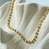 Warren Necklace by Matte, gold filled beaded ball chain on neutral ceramic background