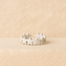 White enamel star ring on a beige background – Stars Adjustable Ring by Matte
