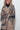 Model styling the Wild Muse Leopard Cardigan open over black turtleneck and pants.