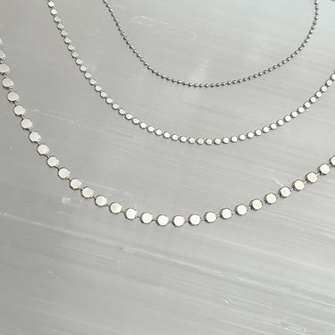 Close-up of Yara Necklace Set 3 by Matte, showing graduated layered gold-plated chains and extender detail