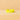Yellow enamel star ring on a soft beige fabric background – Stars Adjustable Ring by Matte
